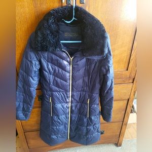 Navy blue, w/ black faux fur collar w/ gold zippers. Lightly used & very warm!